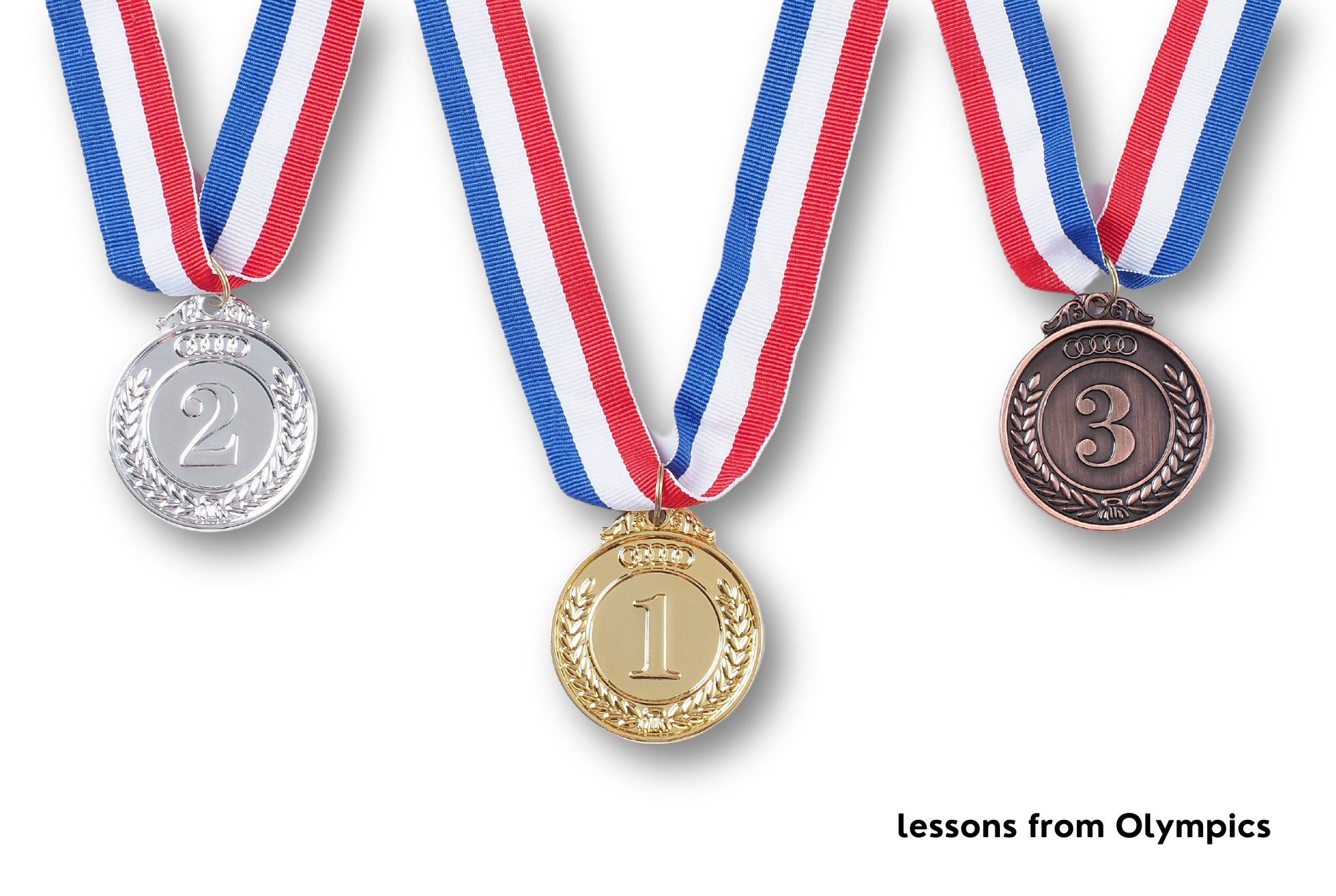 Gold, silver and bronze medals similar to the Olympics hang on red, white, and blue necklaces against a white background.