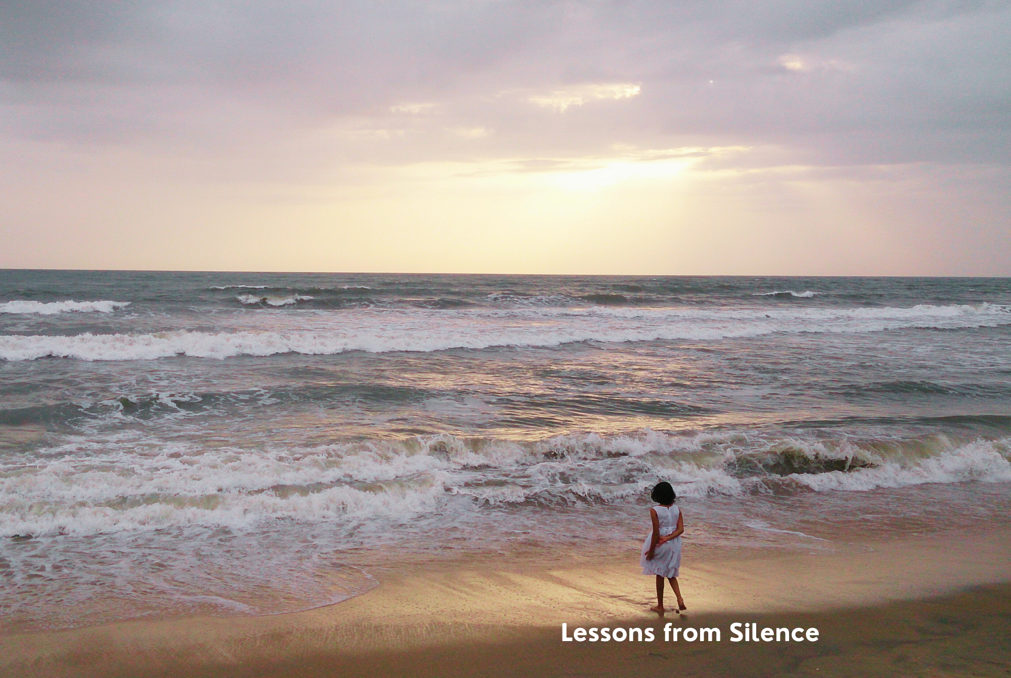 A tween or teen girl spends time in silence to awe at the beauty of the ocean.